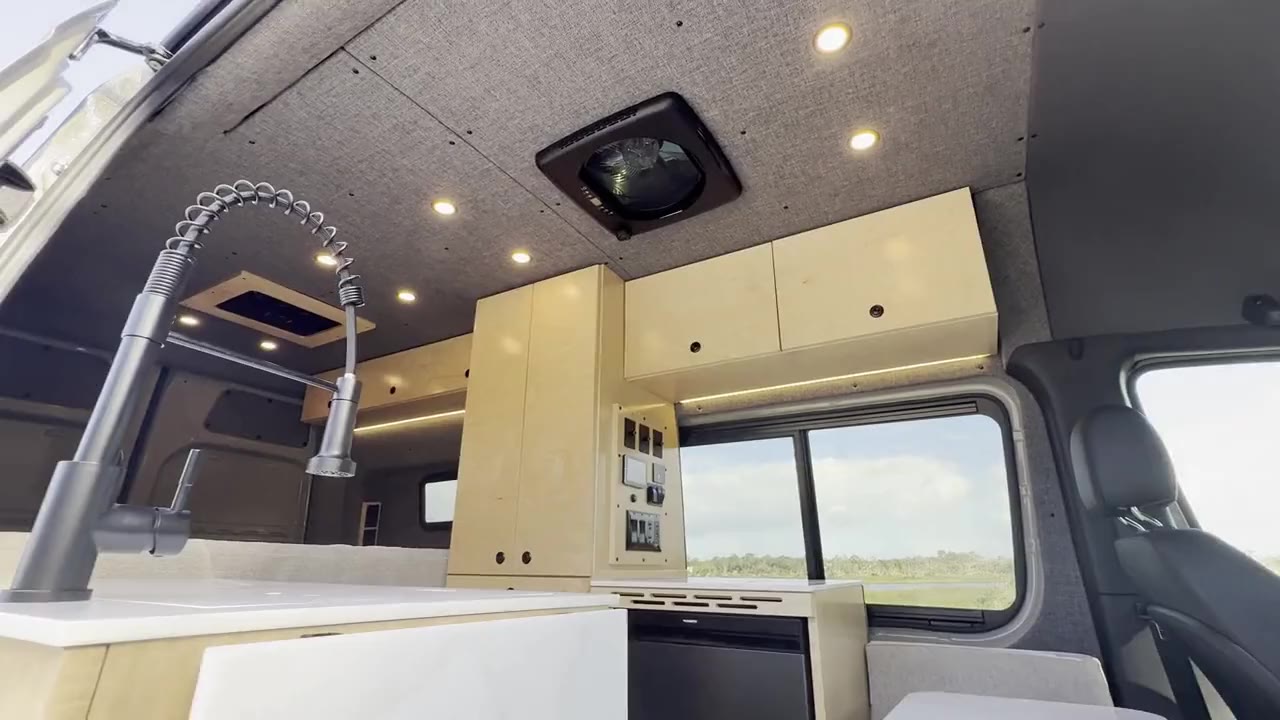 The Drifter galley with a pull-down faucet, maple cabinets and a view out the window