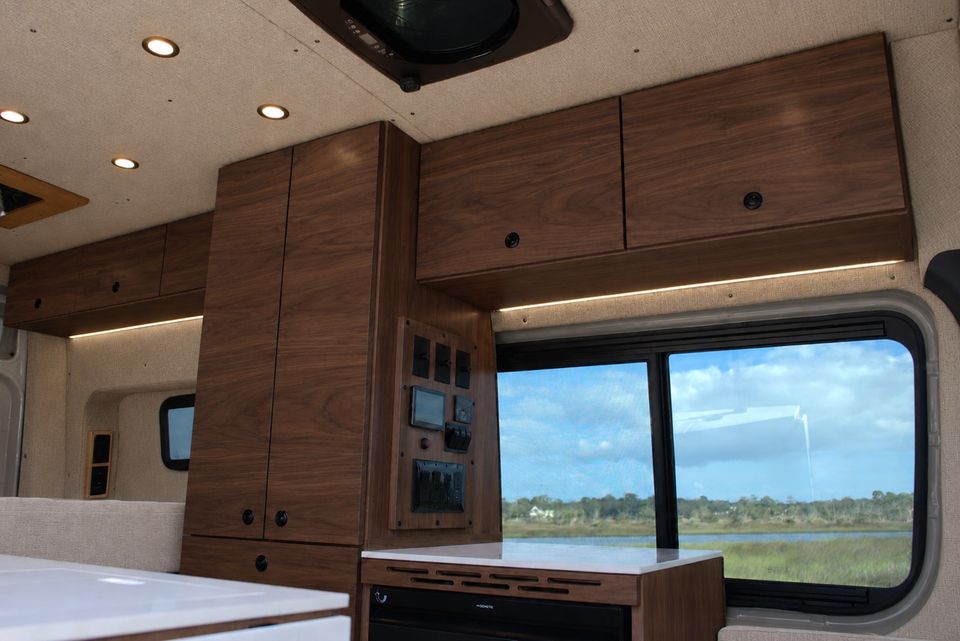 Walnut upper cabinets over maple lowers inside a Drifter