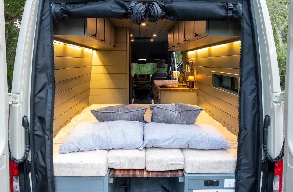 A made-up bed with warm lighting