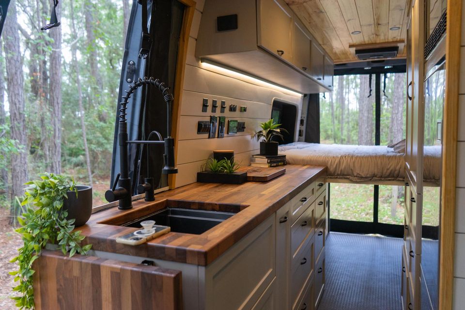 A butcher-block galley with a deep sink and open shelving