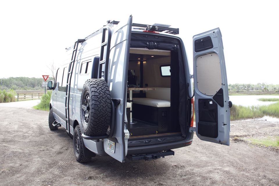 The Gamer Van rear doors open to the bench seat, table and tire carrier