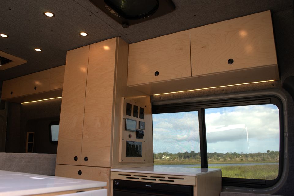 Inside Kai: maple cabinets, dark gray panels and a window onto the marsh
