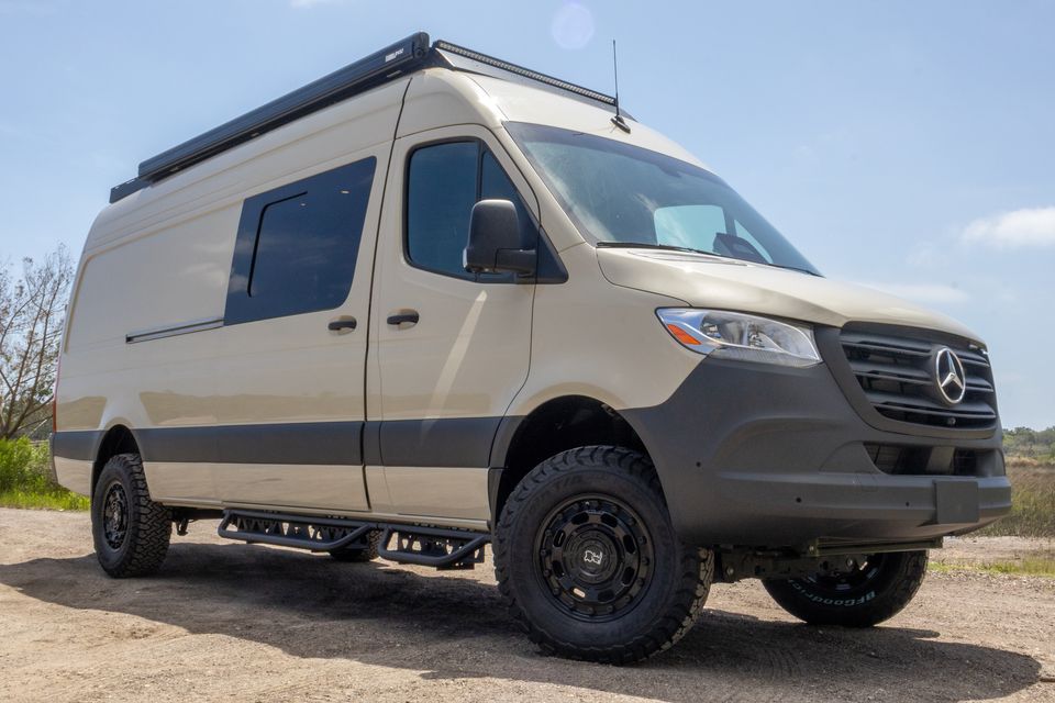 A sand-colored Oasis camper van