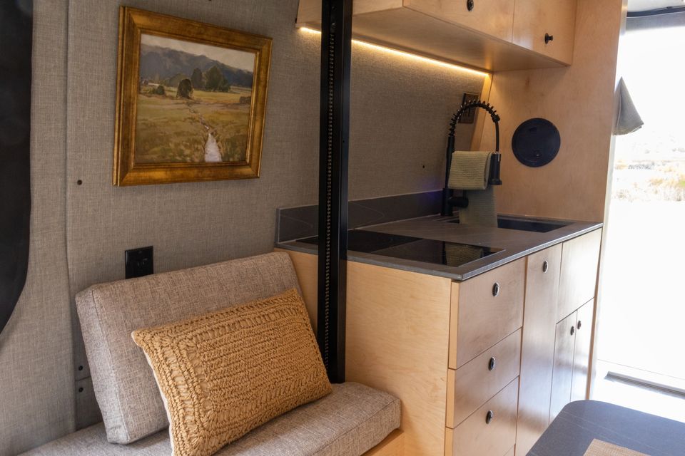 The Oasis kitchen with an induction cooktop and a framed painting